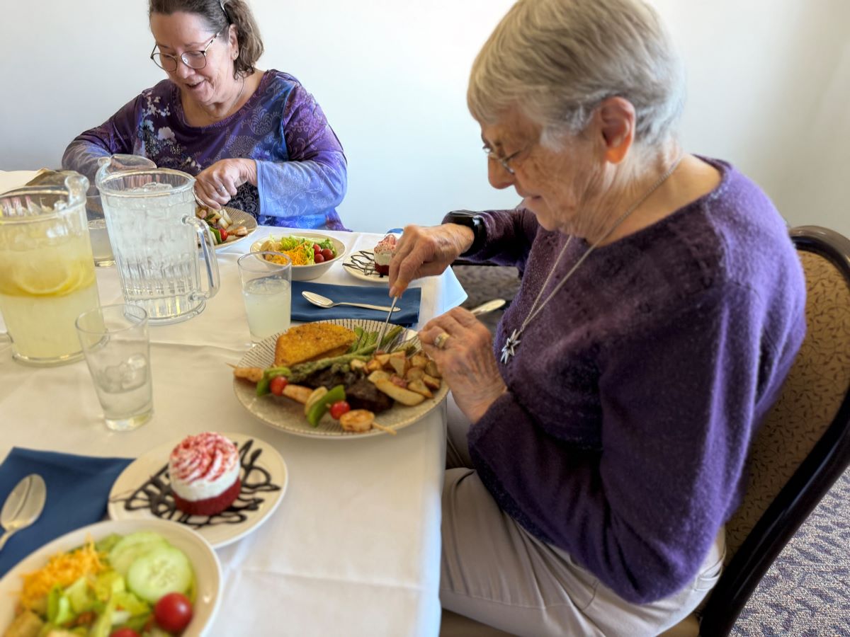 Senior females seated at dinner table